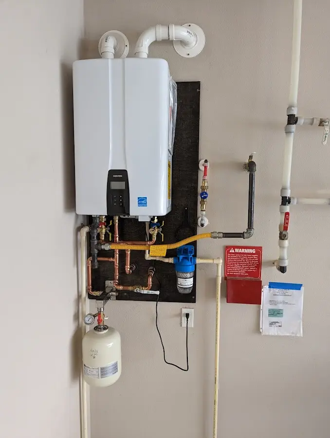 Professional plumber installing copper piping in a Cameron home